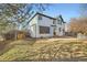 Backyard featuring a lawn, outdoor kitchen, hot tub and a shed with a wooden gate at 10672 Wintersweet Pl, Parker, CO 80134