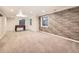 Spacious basement featuring neutral carpet, stone accent wall, and a foosball table at 10672 Wintersweet Pl, Parker, CO 80134
