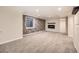 Unfurnished basement with neutral carpet, stone accent wall, and a fireplace at 10672 Wintersweet Pl, Parker, CO 80134