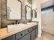 Modern bathroom features double sinks with wood accents and gray cabinetry plus tiled shower at 10672 Wintersweet Pl, Parker, CO 80134