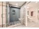 Modern bathroom featuring a glass shower with gray subway tiles, river rock floor and seat, and a niche at 10672 Wintersweet Pl, Parker, CO 80134