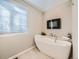 Modern bathroom features a freestanding tub, sleek fixtures, and a decorative plant at 10672 Wintersweet Pl, Parker, CO 80134