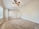 Spacious bedroom with tray ceiling, ceiling fan, and large windows offering natural light at 10672 Wintersweet Pl, Parker, CO 80134