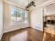 Dining room featuring hardwood floors, a modern light fixture, and a large window providing natural light at 10672 Wintersweet Pl, Parker, CO 80134