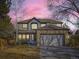 Charming two-story home featuring a stone-accented garage and inviting front porch at 10672 Wintersweet Pl, Parker, CO 80134