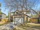 Two-story home with stone accents on the garage, a well-manicured lawn, and mature trees at 10672 Wintersweet Pl, Parker, CO 80134