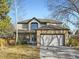 Charming two-story home featuring a stone-accented garage and inviting front porch at 10672 Wintersweet Pl, Parker, CO 80134