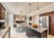 Bright kitchen with stainless steel appliances, granite counters, kitchen island and an open floor plan at 10672 Wintersweet Pl, Parker, CO 80134