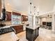 Well-lit kitchen featuring a center island with granite countertop, gas cooktop, and stainless steel appliances at 10672 Wintersweet Pl, Parker, CO 80134