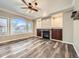 Bright living room features a stone fireplace, built-in cabinets, and large windows for plenty of light at 10672 Wintersweet Pl, Parker, CO 80134
