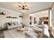 Spacious living room with a modern sofa, decorative shelves, and an open view of the kitchen at 10672 Wintersweet Pl, Parker, CO 80134