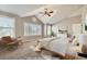 A virtually staged spacious bedroom with neutral walls and carpet, and large windows at 10672 Wintersweet Pl, Parker, CO 80134