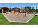 Community playground with swings, slides, and climbing structure with a rubber mulch base and a lawn perimeter at 10672 Wintersweet Pl, Parker, CO 80134