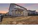 Backyard view of the home shows the covered patio, and new construction of landscaping at 11261 Moonshimmer St, Littleton, CO 80125