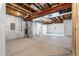 Unfinished basement with exposed ceiling, utility hookups, and painted foundation walls at 11261 Moonshimmer St, Littleton, CO 80125
