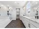 Luxurious bathroom features a soaking tub, glass shower, dual sinks and dark herringbone floors at 11261 Moonshimmer St, Littleton, CO 80125