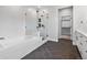 Luxurious bathroom with soaking tub, glass shower and dark herringbone floors at 11261 Moonshimmer St, Littleton, CO 80125