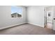 Bright bedroom with a large window offering a view of the neighborhood at 11261 Moonshimmer St, Littleton, CO 80125