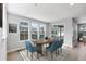 Bright dining area features modern furnishings, a large table, and natural light from the windows at 11261 Moonshimmer St, Littleton, CO 80125