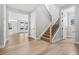 Welcoming entryway with wood floors and staircase, showcasing the home's bright and airy design at 11261 Moonshimmer St, Littleton, CO 80125