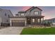 Beautiful two-story home featuring a covered porch with stone accents and a two-car garage at 11261 Moonshimmer St, Littleton, CO 80125