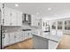 Bright kitchen with stainless steel appliances, white cabinets, and a large island with marble countertops at 11261 Moonshimmer St, Littleton, CO 80125