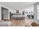 Open concept living room and kitchen with an island with barstool seating and a table with dining seating at 11261 Moonshimmer St, Littleton, CO 80125