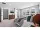 Inviting main bedroom featuring neutral tones, three windows and ensuite bathroom at 11261 Moonshimmer St, Littleton, CO 80125