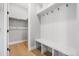 Mudroom with wood floors and convenient built-in bench and coat rack at 11261 Moonshimmer St, Littleton, CO 80125