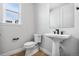 Stylish powder room featuring a pedestal sink, toilet, and window at 11261 Moonshimmer St, Littleton, CO 80125