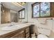 Bathroom features stylish mirror, vanity and toilet at 671 Brentwood St, Lakewood, CO 80214