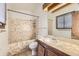 Compact bathroom with a tiled shower and wood vanity with tile top at 671 Brentwood St, Lakewood, CO 80214
