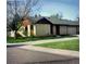 Single story home boasts mature trees, a green lawn and a private entrance at 671 Brentwood St, Lakewood, CO 80214