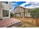 Charming backyard featuring a brick patio and a well-maintained wooden fence at 10626 Cherrybrook Cir, Highlands Ranch, CO 80126