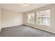 Spacious bedroom with neutral walls, carpet, and natural light from large windows at 10626 Cherrybrook Cir, Highlands Ranch, CO 80126