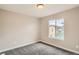 Cozy bedroom features soft carpet, neutral paint, bright window, and white trim at 10626 Cherrybrook Cir, Highlands Ranch, CO 80126