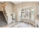 Bright dining area featuring wood floors, large windows, and a modern chandelier at 10626 Cherrybrook Cir, Highlands Ranch, CO 80126