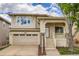 Charming two-story home with a welcoming front porch, stone accents, attached garage, and landscaped front yard at 10626 Cherrybrook Cir, Highlands Ranch, CO 80126