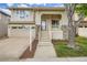 Two-story home featuring a covered front porch, stone accents, an attached garage, and fresh landscaping at 10626 Cherrybrook Cir, Highlands Ranch, CO 80126