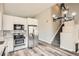 Modern kitchen with stainless steel appliances, white cabinets, hard surface countertops, and an open staircase at 10626 Cherrybrook Cir, Highlands Ranch, CO 80126