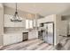 Modern kitchen with white cabinets, stainless steel appliances, hard surface countertops, and stylish lighting at 10626 Cherrybrook Cir, Highlands Ranch, CO 80126
