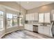 Beautiful kitchen with white cabinetry, stainless steel appliances, hard surface countertops, and large windows at 10626 Cherrybrook Cir, Highlands Ranch, CO 80126