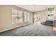Bright living room with natural light, carpet, access to the yard, and open doorway to the kitchen at 10626 Cherrybrook Cir, Highlands Ranch, CO 80126