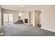 Comfortable living room with a fireplace, carpet, sliding door to the exterior, and an open doorway at 10626 Cherrybrook Cir, Highlands Ranch, CO 80126