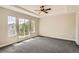 Generous main bedroom with carpet, large windows, and a ceiling fan at 10626 Cherrybrook Cir, Highlands Ranch, CO 80126