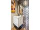 This bathroom features a sleek vanity, an oval mirror, and modern hexagon tile at 1863 Wazee St # 6B, Denver, CO 80202