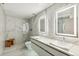 Sleek bathroom with marble walls, dual sinks, and glass-enclosed shower at 1863 Wazee St # 6B, Denver, CO 80202
