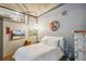 A bedroom with hardwood floors, a plush bed, and unique wall art at 1863 Wazee St # 6B, Denver, CO 80202