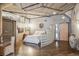A modern bedroom with industrial-style ceilings, glass block wall, and minimalist decor at 1863 Wazee St # 6B, Denver, CO 80202