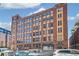 Exterior view of the brick apartment building on a sunny day with street view at 1863 Wazee St # 6B, Denver, CO 80202